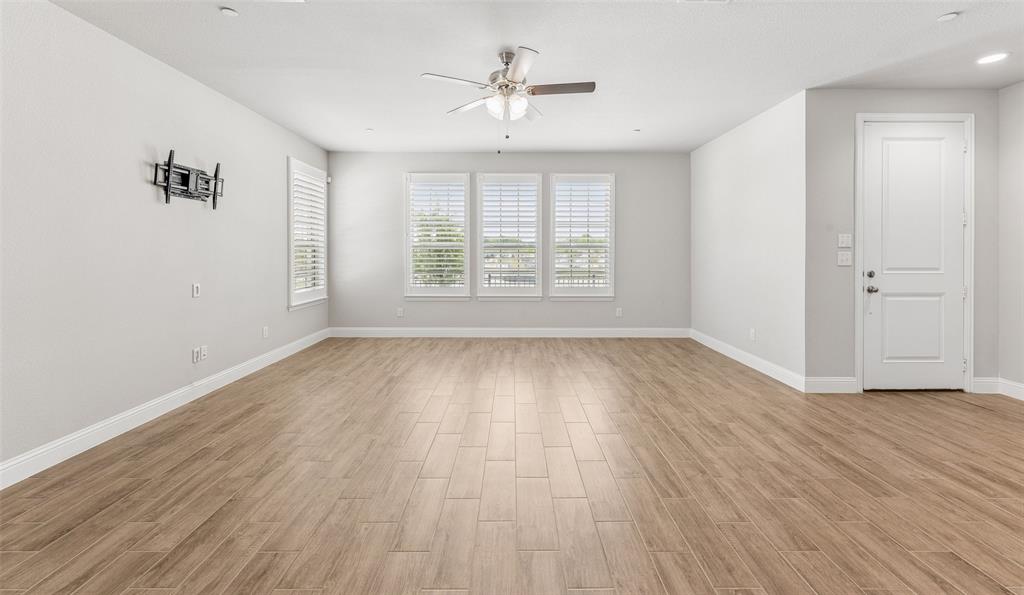6020 Bursey Road Watauga, TX 76148 - Photo 7 of 33 wooden floor in an empty room with a window
