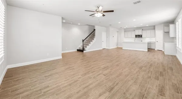 a view of a kitchen with furniture and a ceiling fan