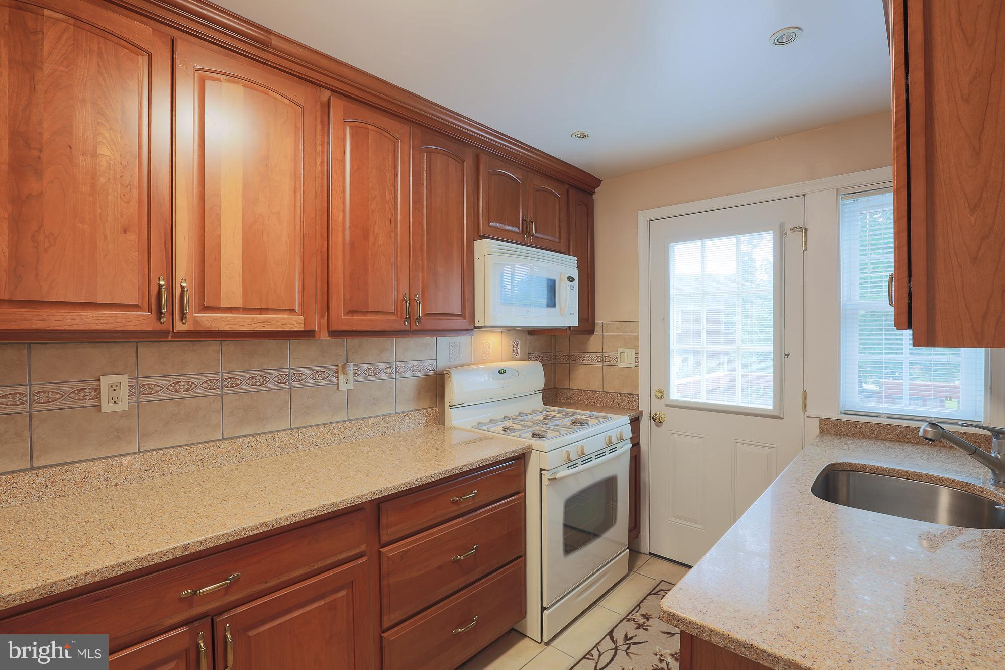 1727 Edgewood Road Towson, MD 21286 - Photo 19 of 29 a kitchen with a sink stove and cabinets