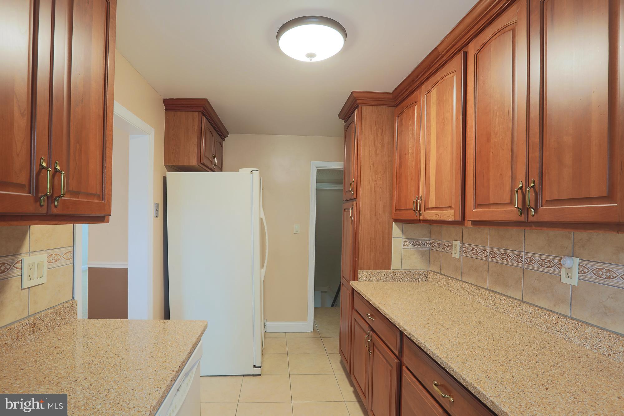 1727 Edgewood Road Towson, MD 21286 - Photo 21 of 29 a kitchen with stainless steel appliances granite countertop a refrigerator and a sink