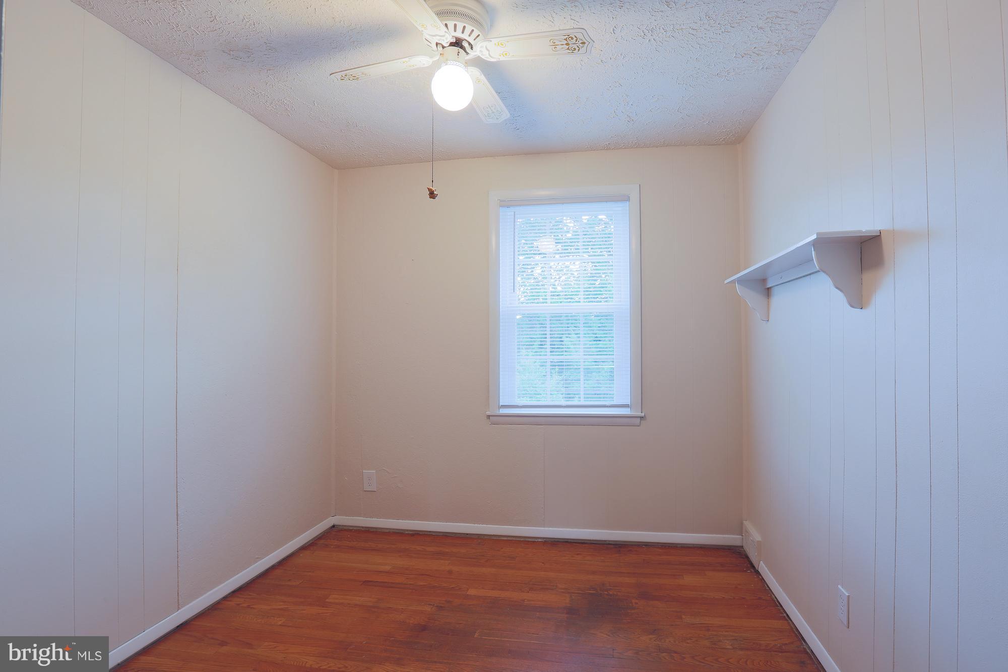 1727 Edgewood Road Towson, MD 21286 - Photo 24 of 29 an empty room with a window and a fan