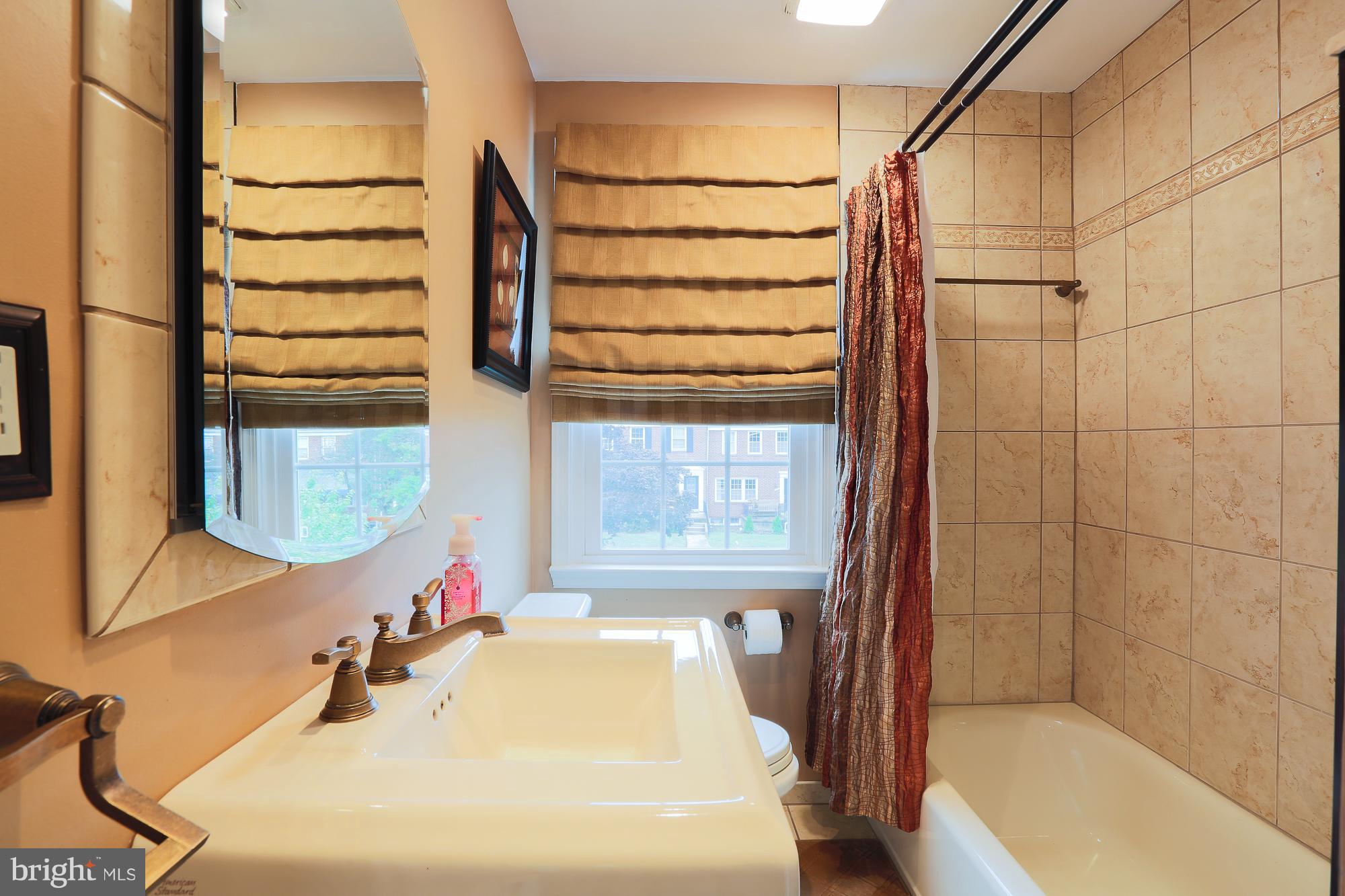 1727 Edgewood Road Towson, MD 21286 - Photo 25 of 29 a bathroom with a tub sink and mirror