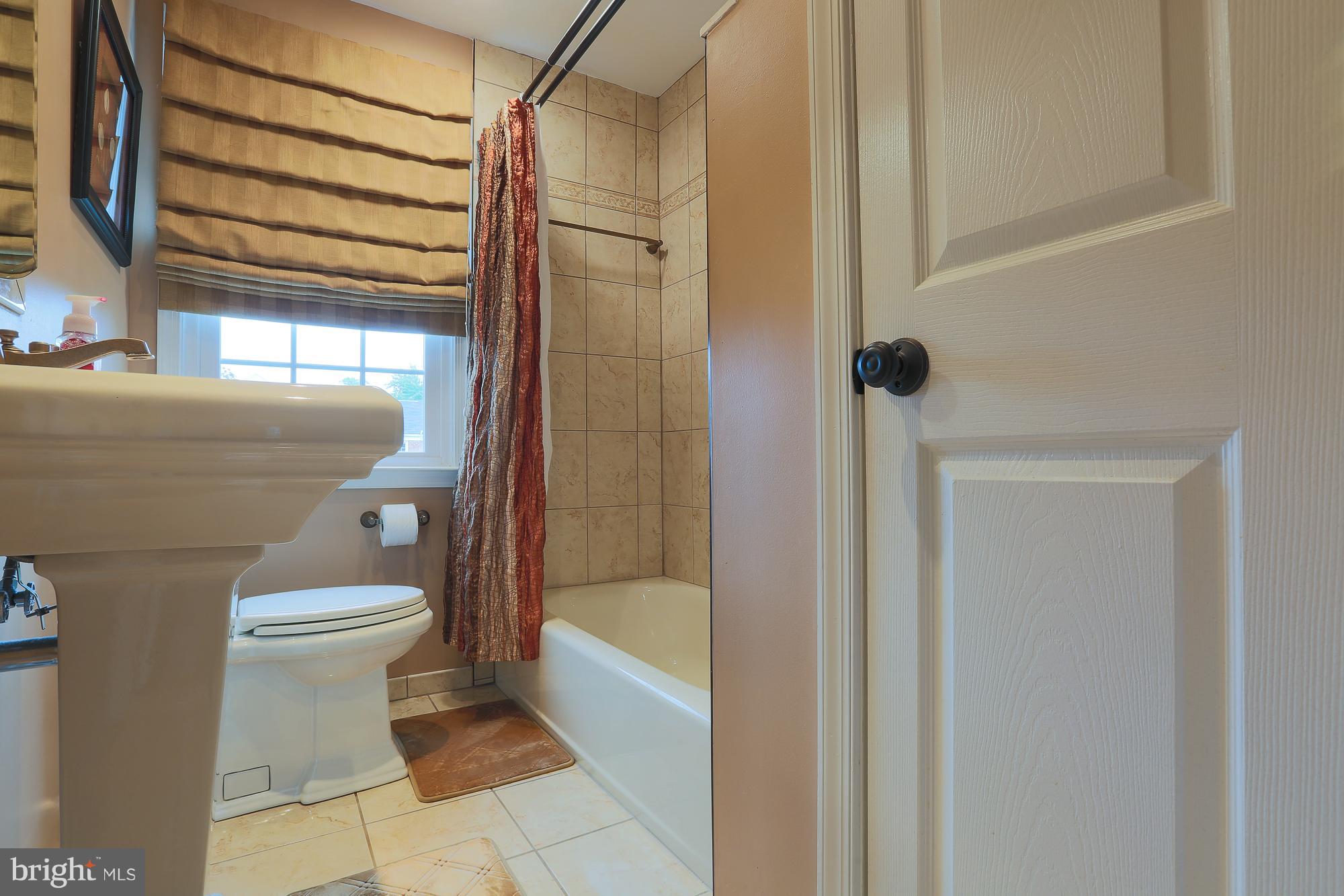 1727 Edgewood Road Towson, MD 21286 - Photo 26 of 29 a bathroom with a bathtub and shower