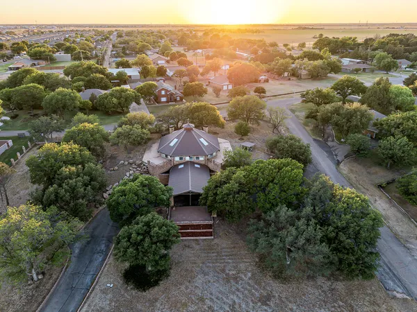 an aerial view of a house with yard