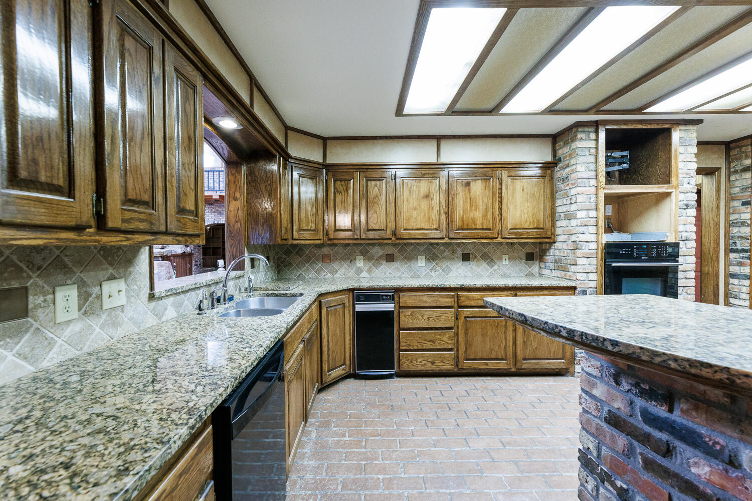 409 Mill Road Lubbock, TX 79403 - Photo 23 of 86 a kitchen with stainless steel appliances granite countertop a sink stove and cabinets
