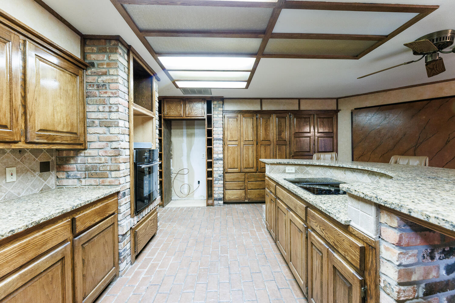 409 Mill Road Lubbock, TX 79403 - Photo 25 of 86 a kitchen with granite countertop a sink and a refrigerator