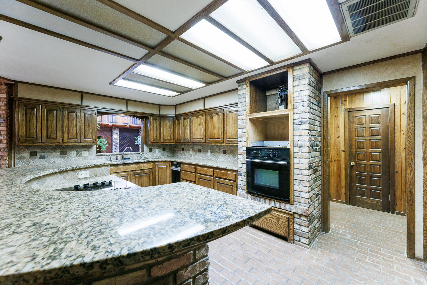 409 Mill Road Lubbock, TX 79403 - Photo 28 of 86 a kitchen with stainless steel appliances granite countertop a sink a stove counter space and cabinets