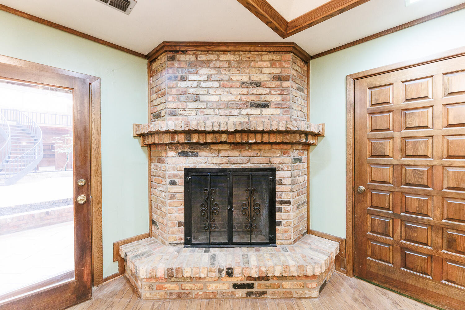 409 Mill Road Lubbock, TX 79403 - Photo 38 of 86 a living room with a fireplace cabinet and a large window