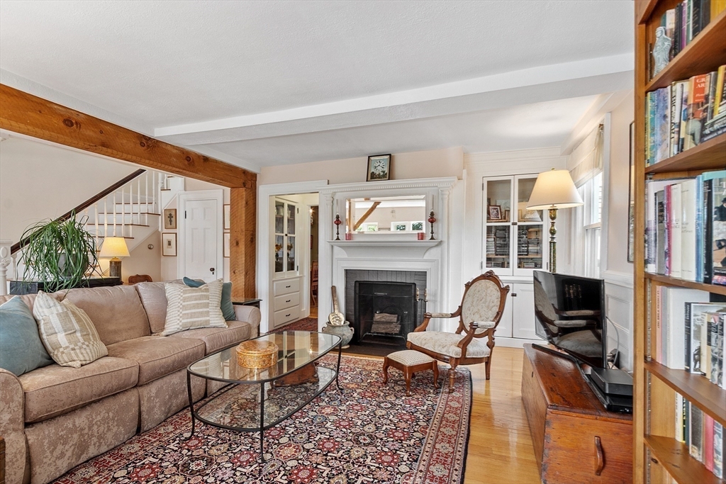 394 Plainfield Road, Unit 394 Concord, MA 01742 - Photo 15 of 40 a living room with furniture a fireplace and a large window