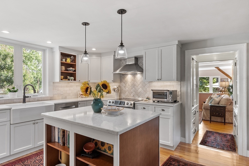 394 Plainfield Road, Unit 394 Concord, MA 01742 - Photo 16 of 40 a kitchen with stainless steel appliances granite countertop a sink a stove and a wooden floors
