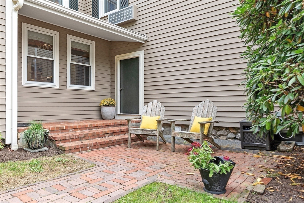 394 Plainfield Road, Unit 394 Concord, MA 01742 - Photo 22 of 40 a view of a patio with chairs and potted plants