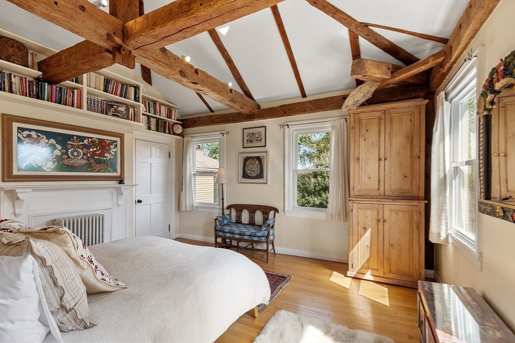 394 Plainfield Road, Unit 394 Concord, MA 01742 - Photo 27 of 40 a bed room with a bed and a chair