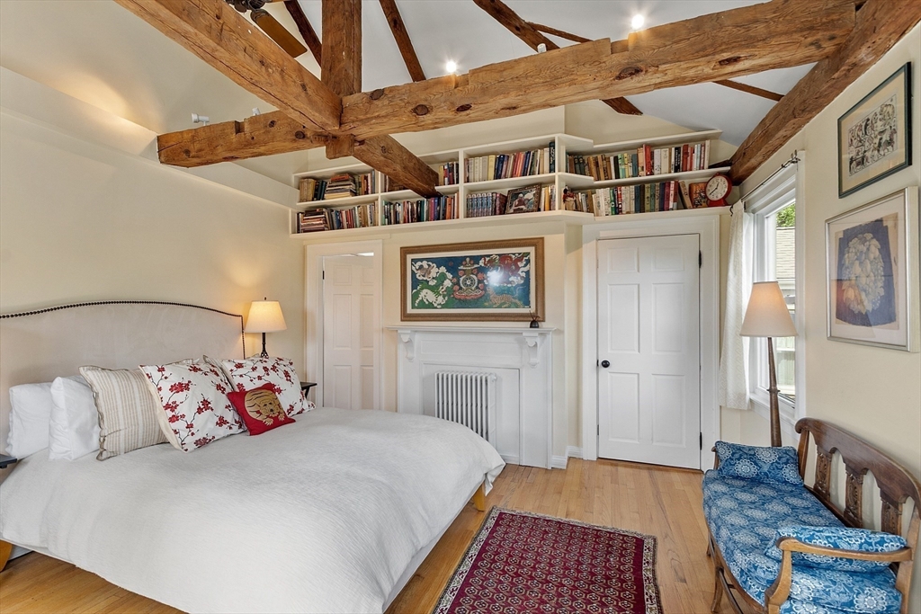394 Plainfield Road, Unit 394 Concord, MA 01742 - Photo 28 of 40 a spacious bedroom with a bed and a dresser in it