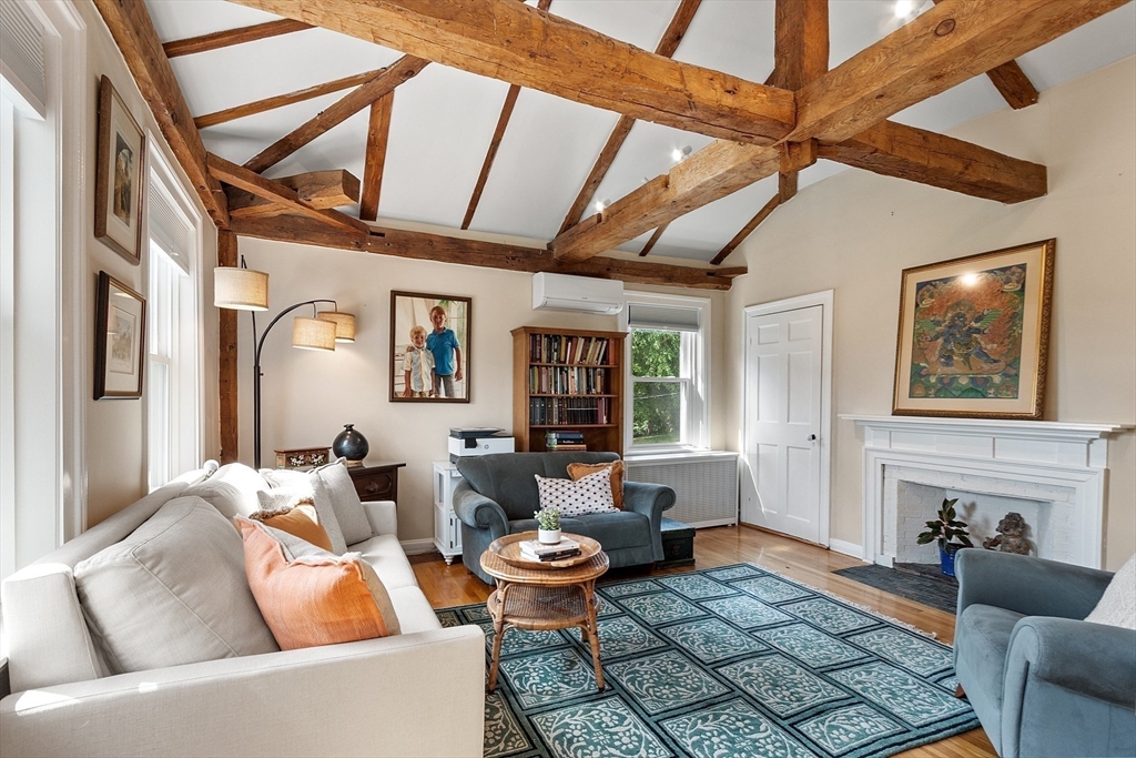 394 Plainfield Road, Unit 394 Concord, MA 01742 - Photo 32 of 40 a living room with furniture and a fireplace