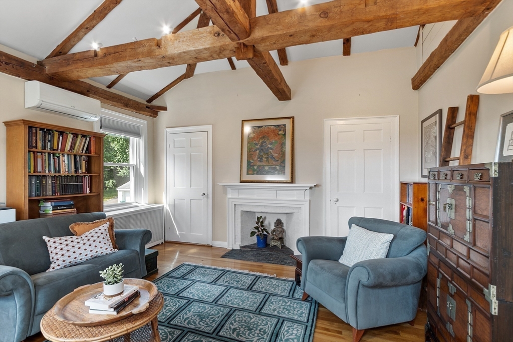 394 Plainfield Road, Unit 394 Concord, MA 01742 - Photo 33 of 40 a living room with furniture and a fireplace