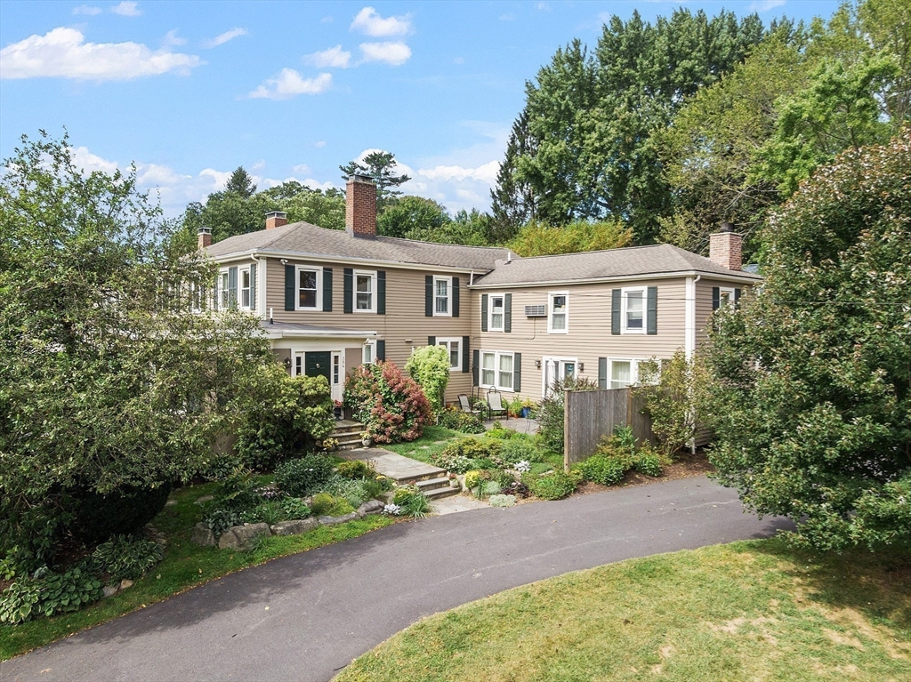 394 Plainfield Road, Unit 394 Concord, MA 01742 - Photo 39 of 40 a front view of a house with a yard and outdoor seating