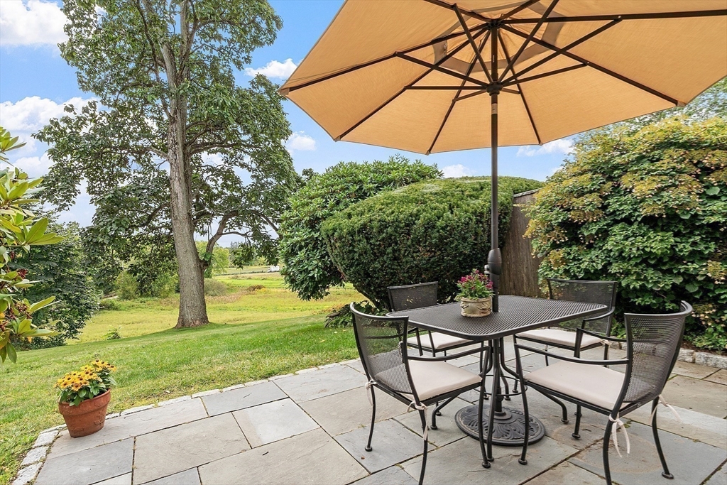 394 Plainfield Road, Unit 394 Concord, MA 01742 - Photo 5 of 40 a table and chairs in the garden