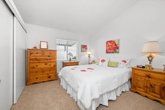 a bedroom with a bed and a dresser in it