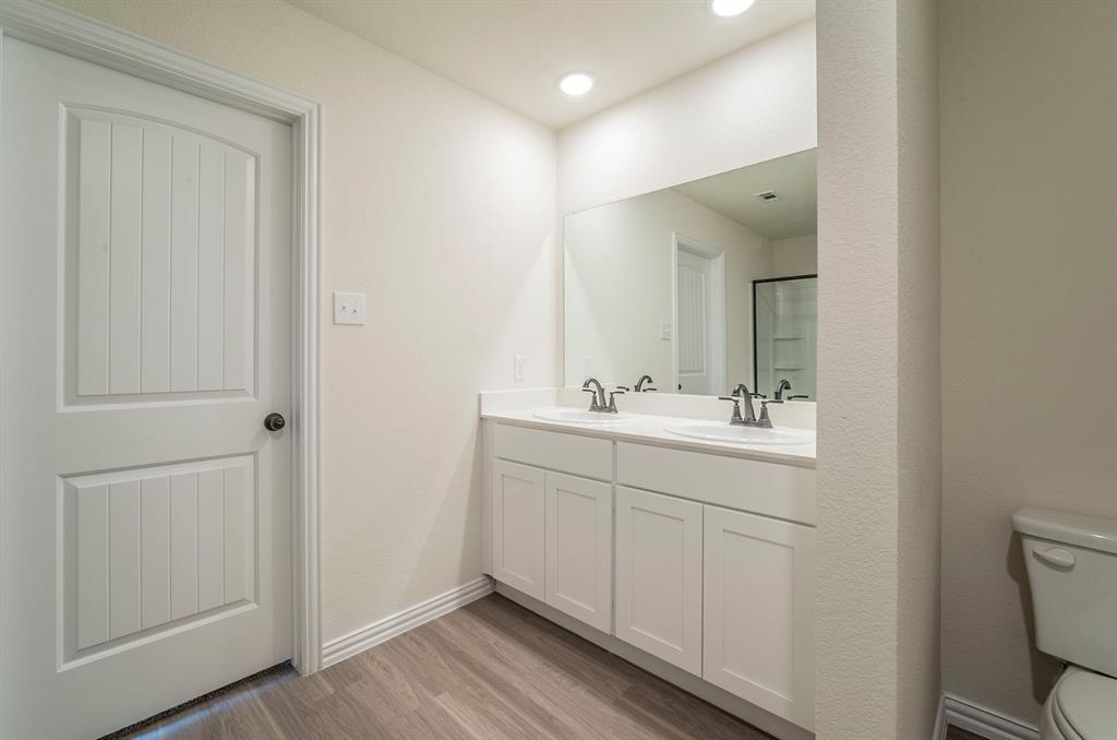 404 Rose Avenue Cleburne, TX 76033 - Photo 8 of 14 a bathroom with a sink mirror and vanity