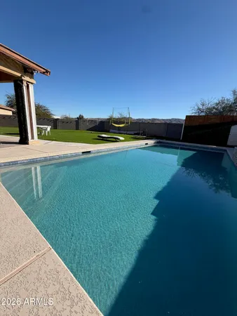 a view of swimming pool with an outdoor seating