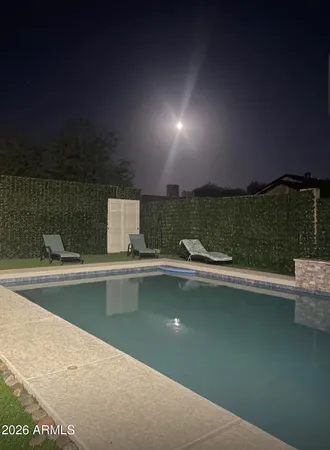 a living room with a bed furniture and a window
