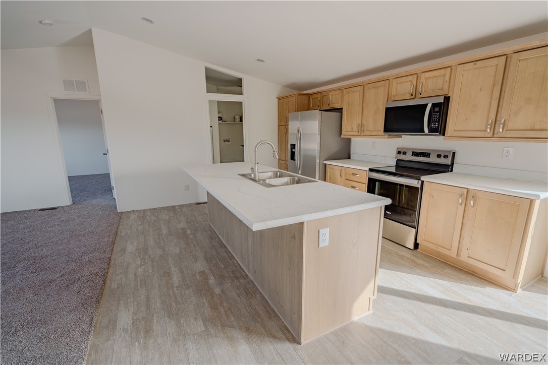 5746 Eden Road Golden Valley, AZ 86413 - Photo 7 of 27 a kitchen with a sink a microwave a stove and refrigerator