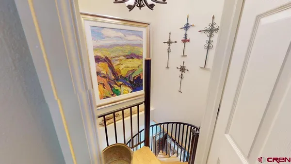 a view of a hallway with wooden floor and door