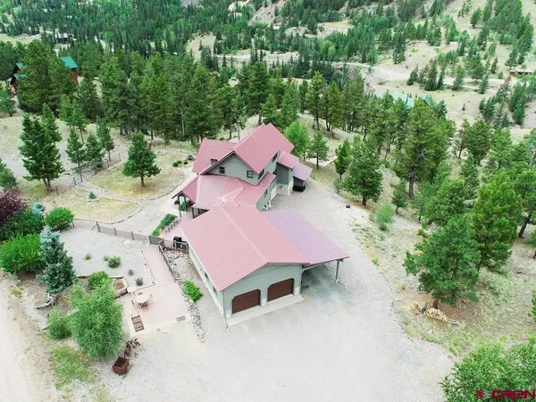an aerial view of a house with a yard