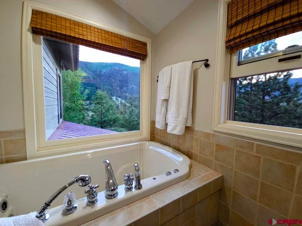 a bathroom with a bathtub and a window
