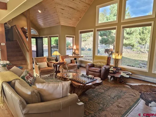 a living room with furniture and large windows