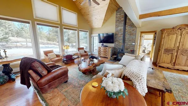 a living room with furniture fireplace and a large window