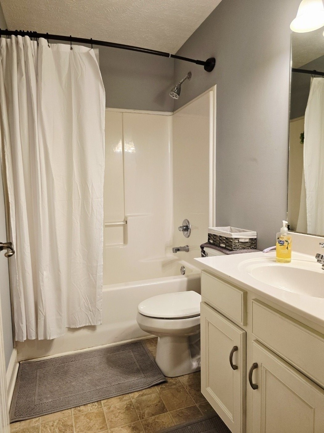 135 Excell Road, Unit 1003 Clarksville, TN 37043 - Photo 12 of 39 a bathroom with a sink a toilet and shower curtain