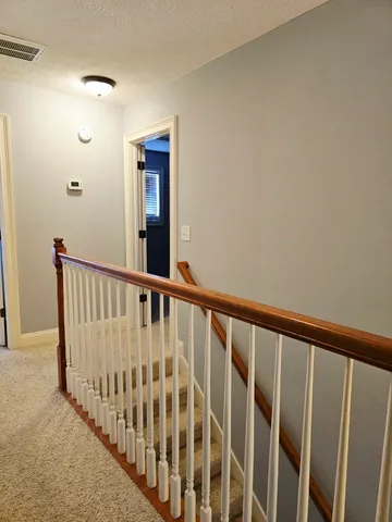 a view of staircase with rug floor