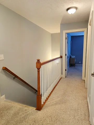 a view of a hallway with staircase