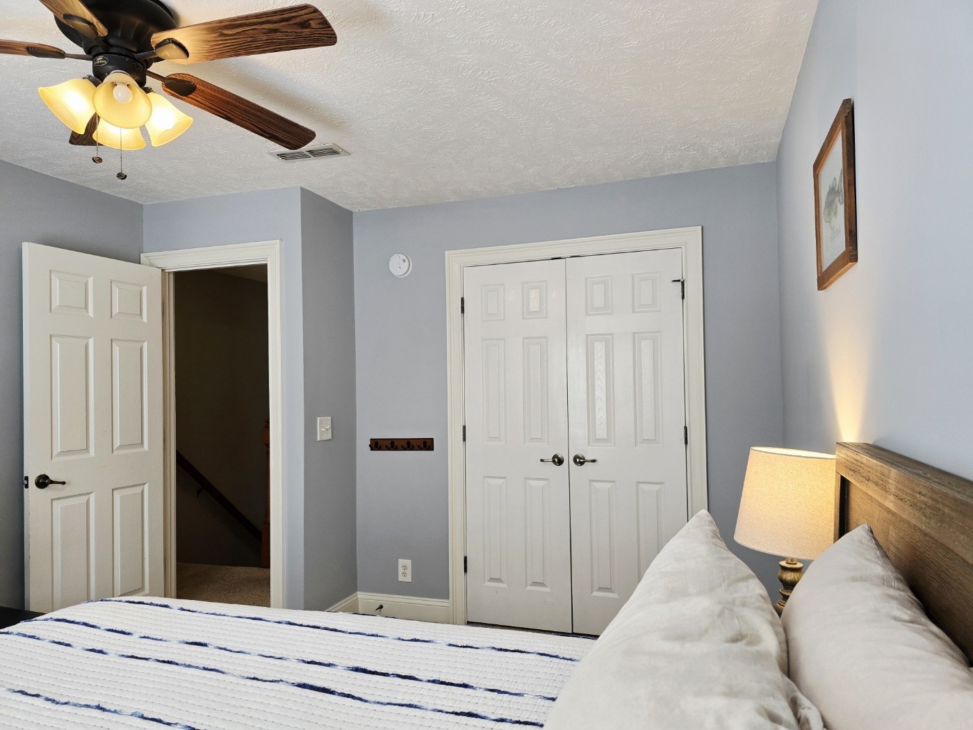 135 Excell Road, Unit 1003 Clarksville, TN 37043 - Photo 26 of 39 a bedroom with a bed and a chandelier
