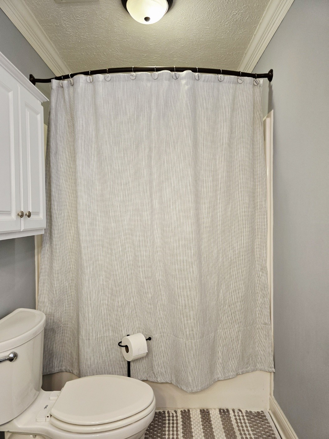 135 Excell Road, Unit 1003 Clarksville, TN 37043 - Photo 30 of 39 a white toilet sitting next to a shower curtain