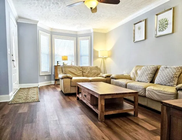 a spacious bedroom with a bed and wooden floor