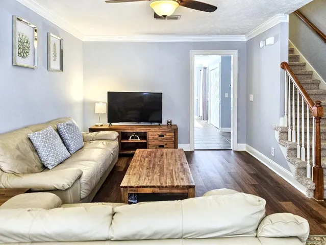 a living room with furniture and a flat screen tv