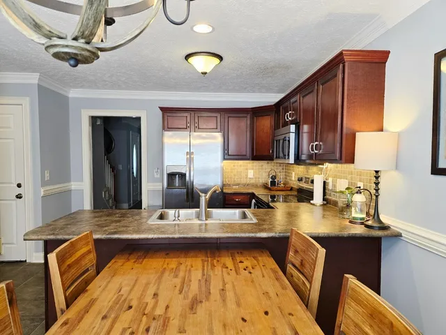 a kitchen with a sink and a stove top oven