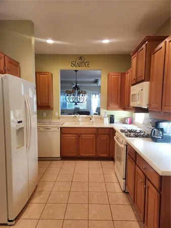 a kitchen with stainless steel appliances a refrigerator sink and cabinets