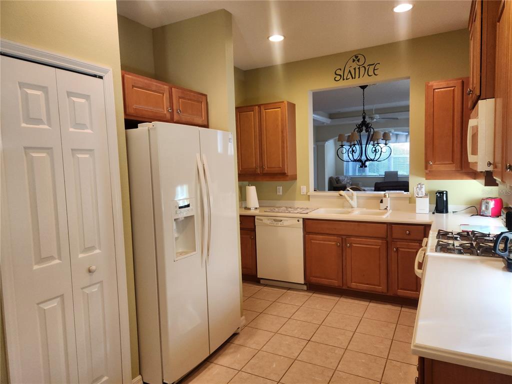 6642 Tailfeather Way Bradenton, FL 34203 - Photo 12 of 28 a kitchen with a refrigerator sink and cabinets