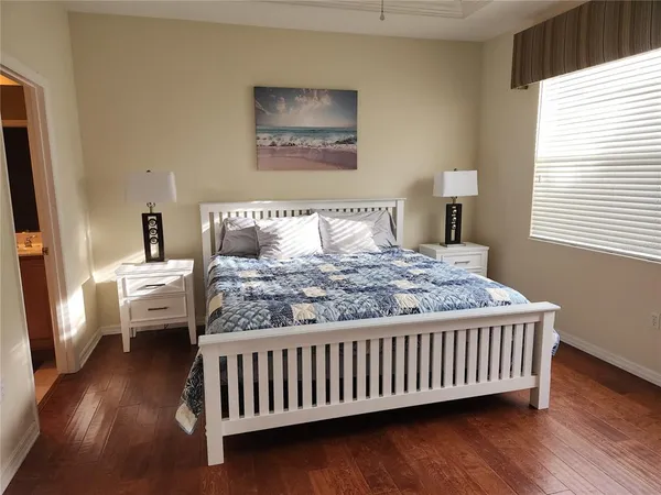 a bedroom with a bed and a flat screen tv