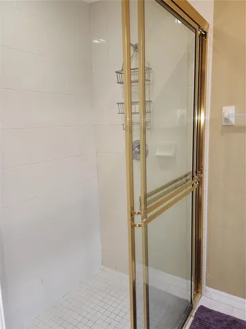 a bathroom with a glass shower door
