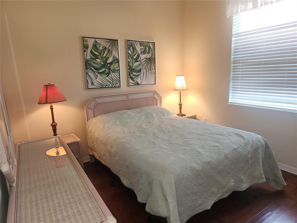 6642 Tailfeather Way Bradenton, FL 34203 - Photo 21 of 28 a bed sitting in a bedroom next to a window