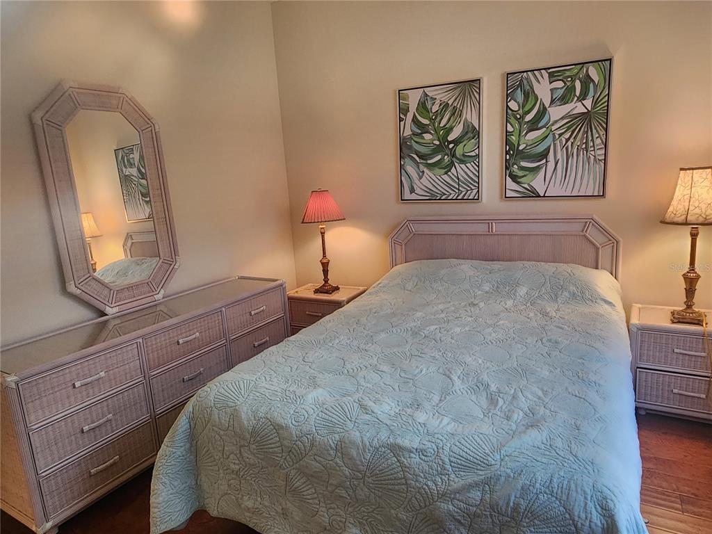 6642 Tailfeather Way Bradenton, FL 34203 - Photo 22 of 28 a bedroom with a bed and a mirror on dresser