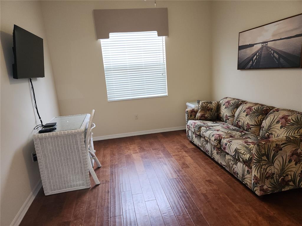 6642 Tailfeather Way Bradenton, FL 34203 - Photo 24 of 28 a living room with furniture and a flat screen tv