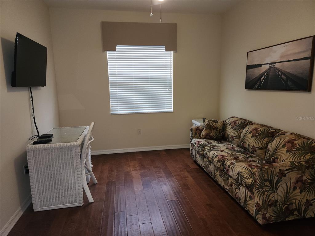 6642 Tailfeather Way Bradenton, FL 34203 - Photo 25 of 28 a living room with furniture and a flat screen tv