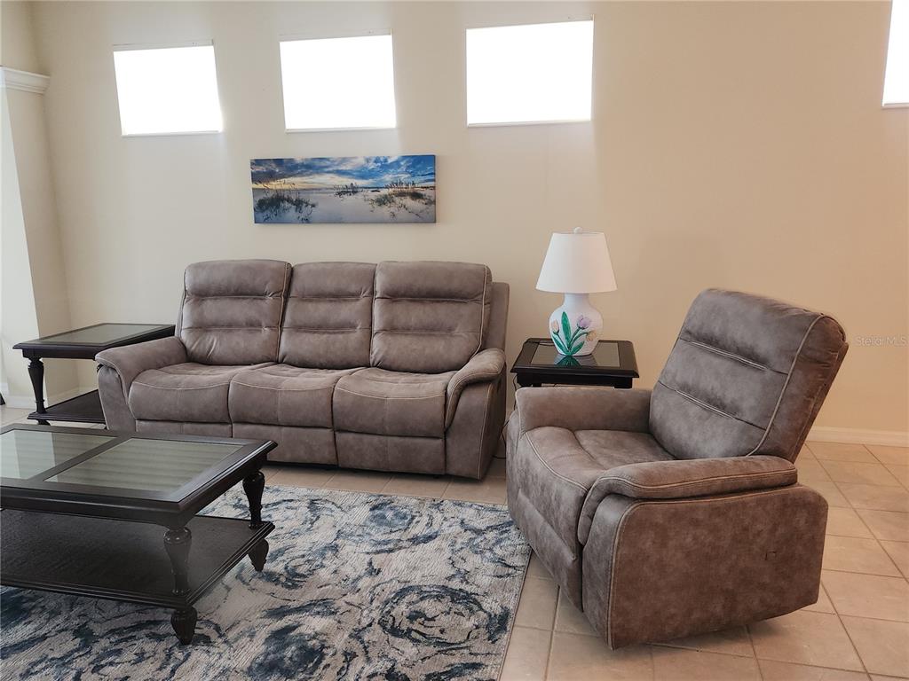 6642 Tailfeather Way Bradenton, FL 34203 - Photo 4 of 28 a living room with furniture and a couch