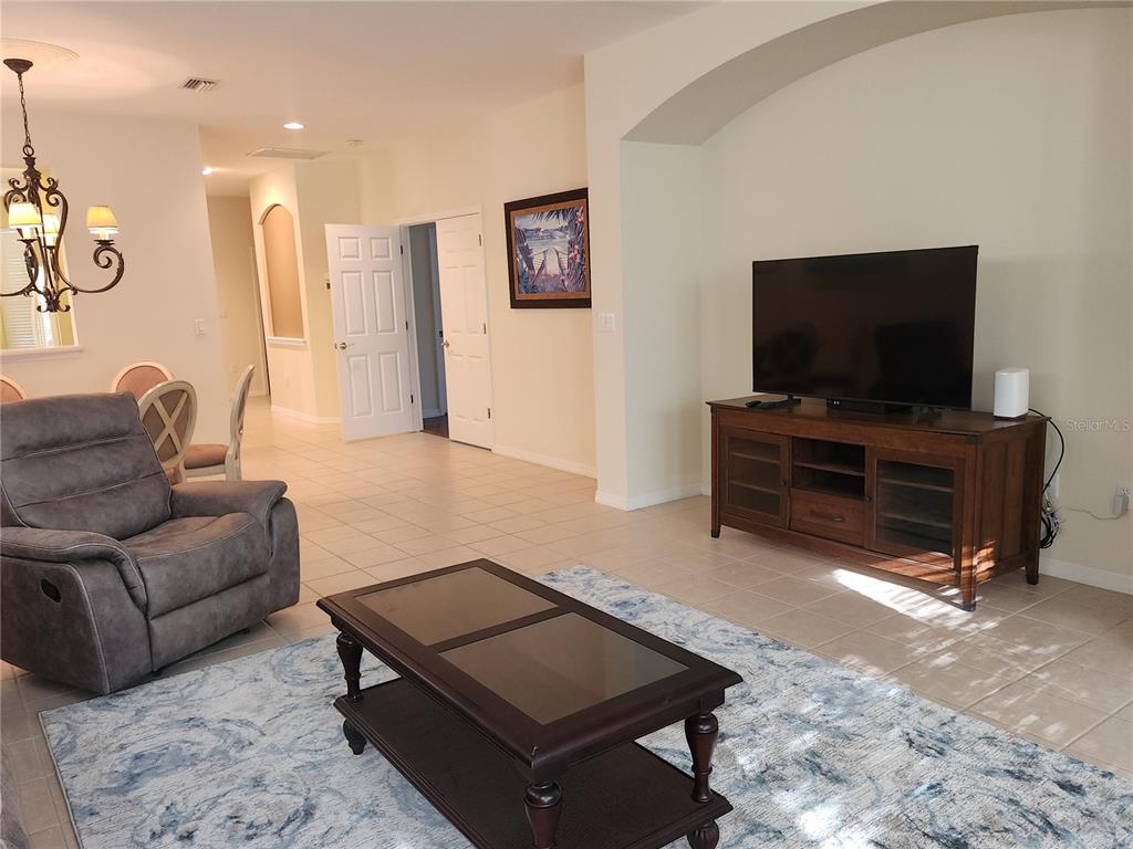 6642 Tailfeather Way Bradenton, FL 34203 - Photo 5 of 28 a living room with furniture and a flat screen tv