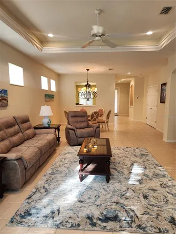 a living room with furniture and a chandelier